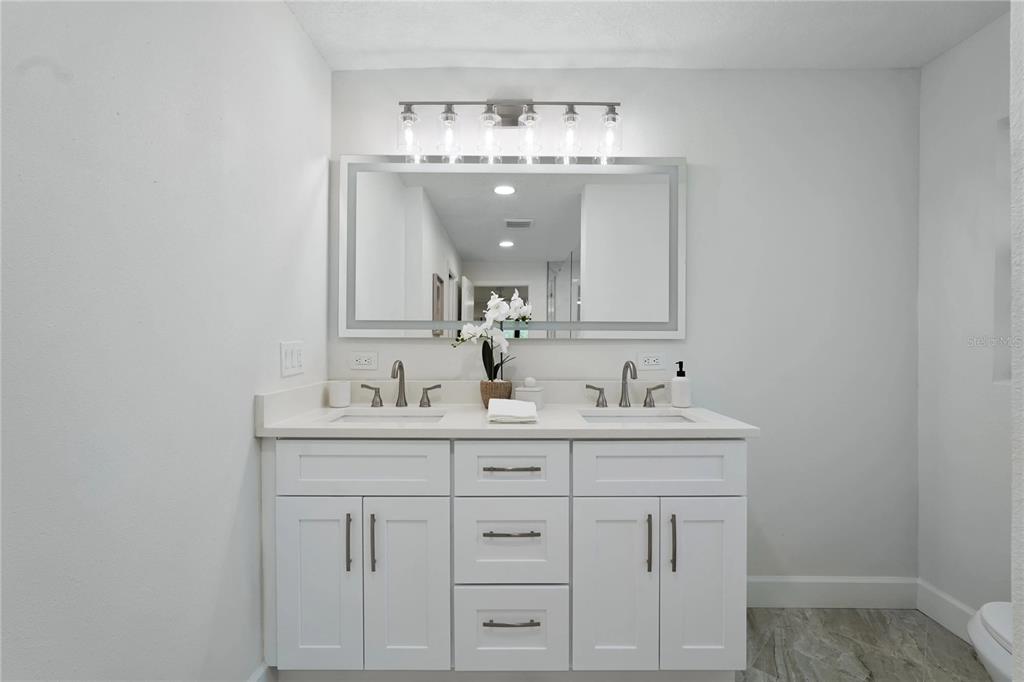 5012 South Deepwater Point Homosassa, FL 34448 - Photo 13 of 42 a bathroom with a sink a light fixture and a vanity