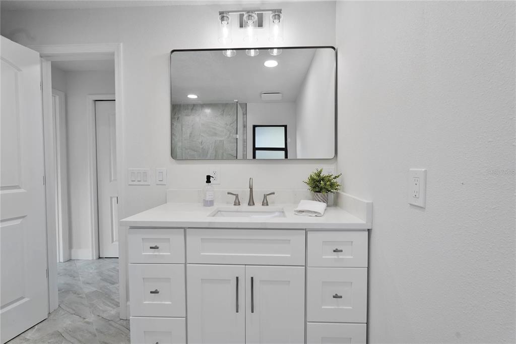 5012 South Deepwater Point Homosassa, FL 34448 - Photo 17 of 42 a bathroom with a sink vanity and mirror