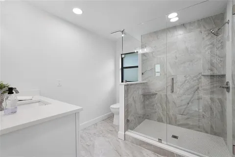 a bathroom with a shower and a sink