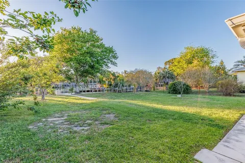 an aerial view of a house a yard and a fountain