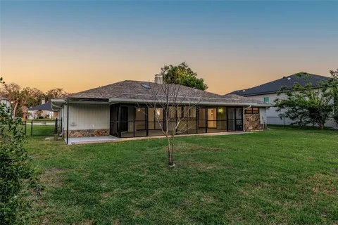 a view of a house with a yard and a garden