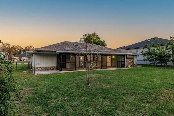 a view of a house with a yard and a garden