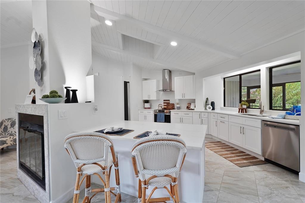 5012 South Deepwater Point Homosassa, FL 34448 - Photo 7 of 42 a kitchen with stainless steel appliances granite countertop a dining table chairs refrigerator and sink