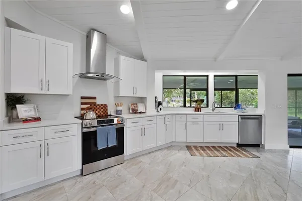 a kitchen with a sink stove and window