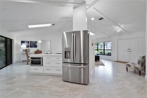 a kitchen with a refrigerator and a stove top oven
