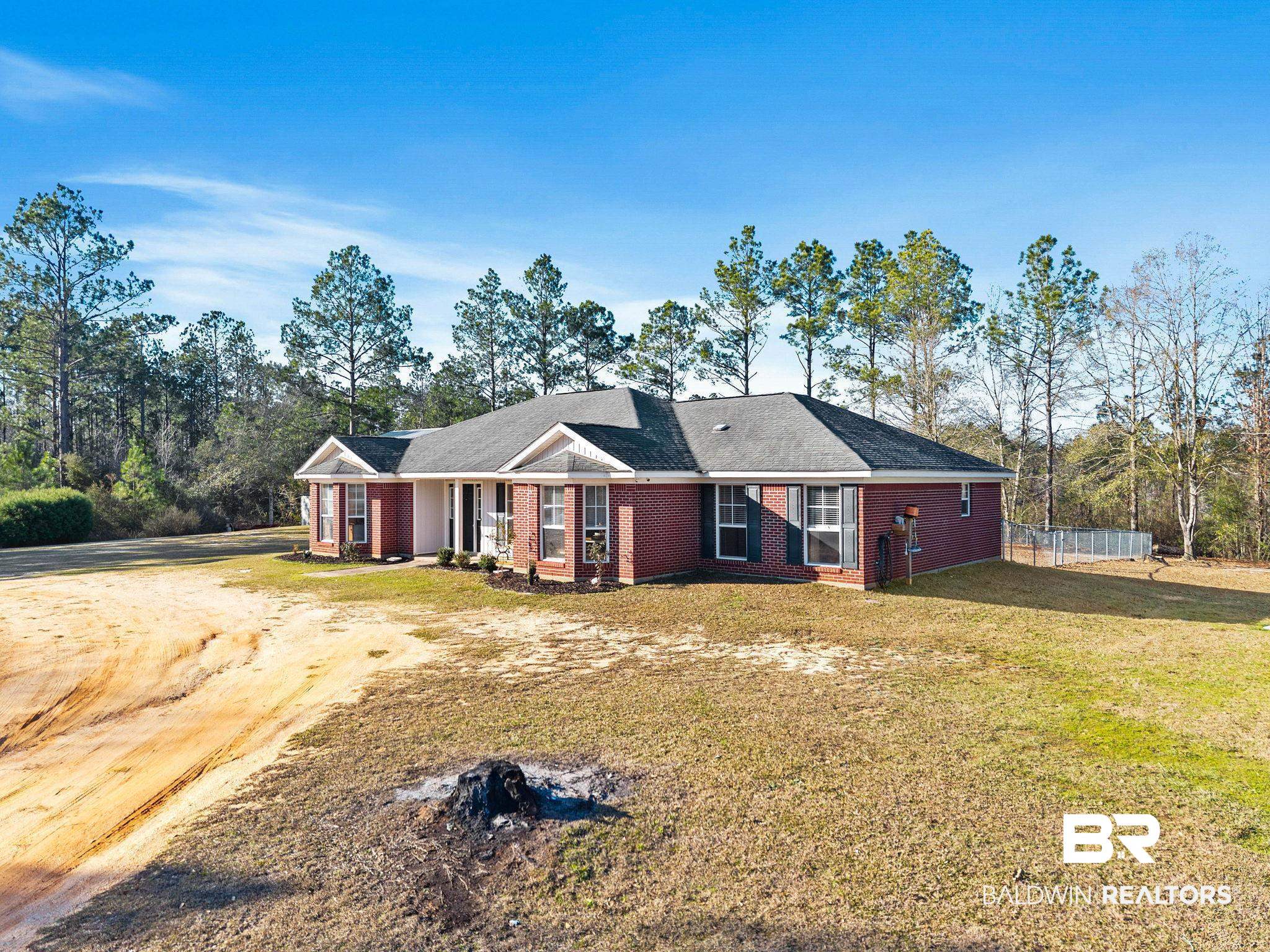 55750 Lottie Road Perdido, AL 36562 - Photo 80 of 84 View of front facade featuring a front yard, brick siding, and dirt driveway