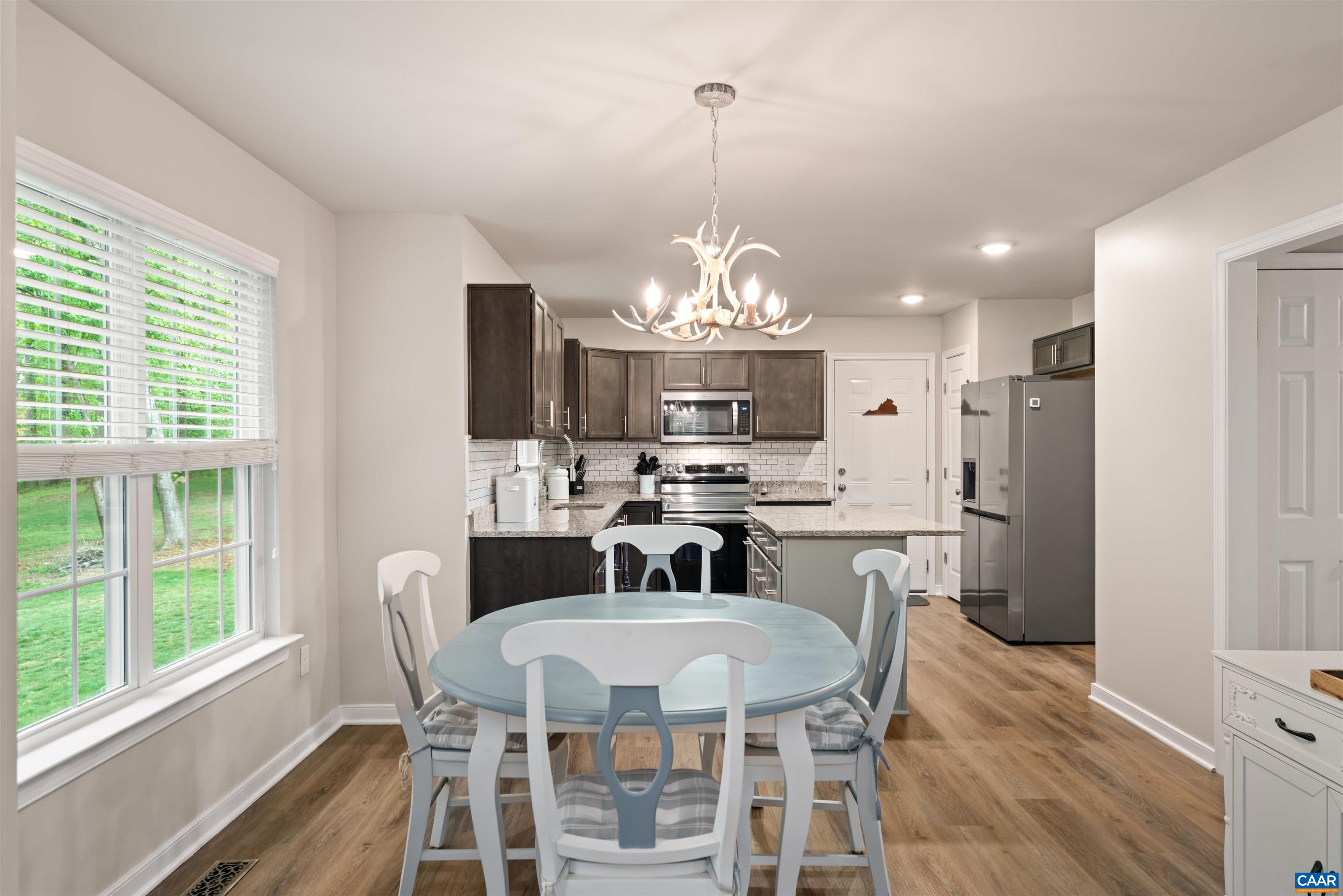 1760 Haden Martin Road Palmyra, VA 22963 - Photo 20 of 51 a view of a dining room with furniture a chandelier and wooden floor