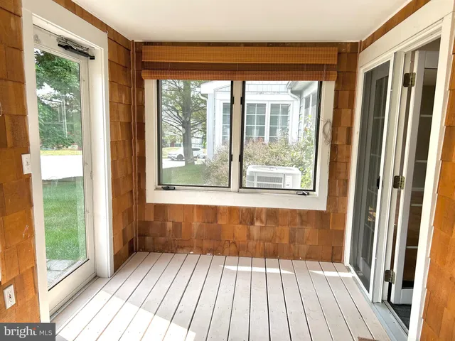 a view of a room with wooden floor and windows