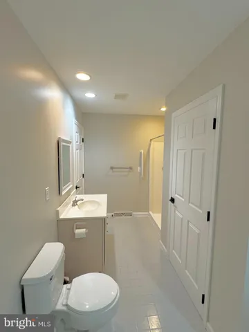 a white toilet sitting next to a bathroom sink