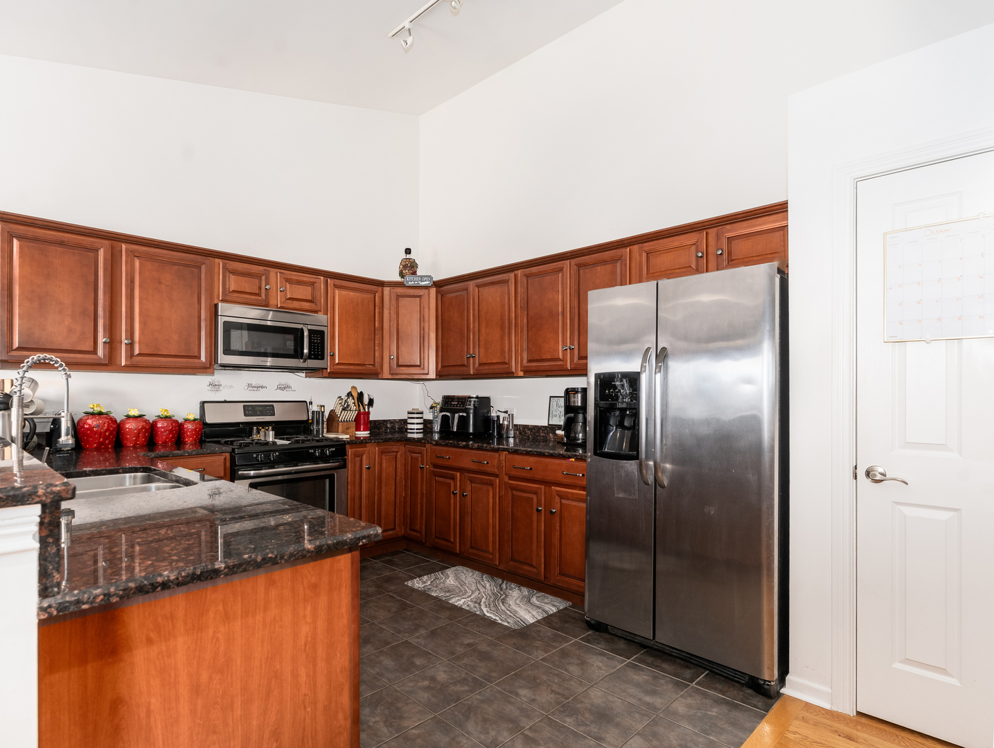 1923 Waters Edge Drive Minooka, IL 60447 - Photo 11 of 24 a kitchen with stainless steel appliances granite countertop a refrigerator a stove top oven a sink and dishwasher