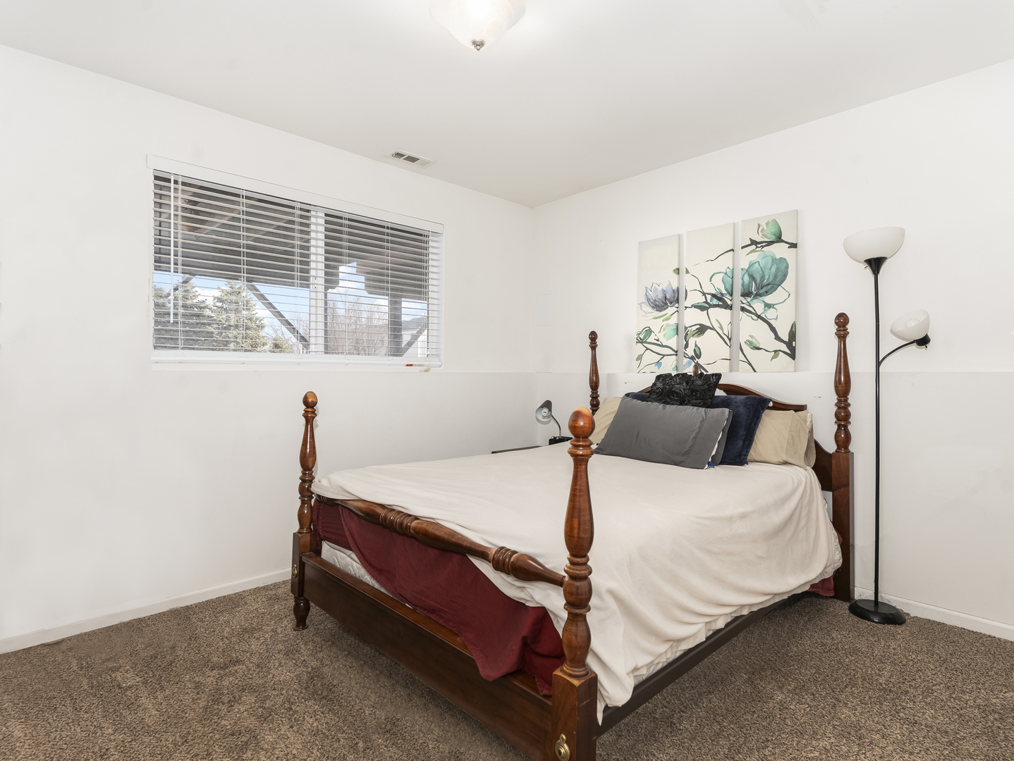 1923 Waters Edge Drive Minooka, IL 60447 - Photo 20 of 24 a bed sitting in a bedroom next to a window