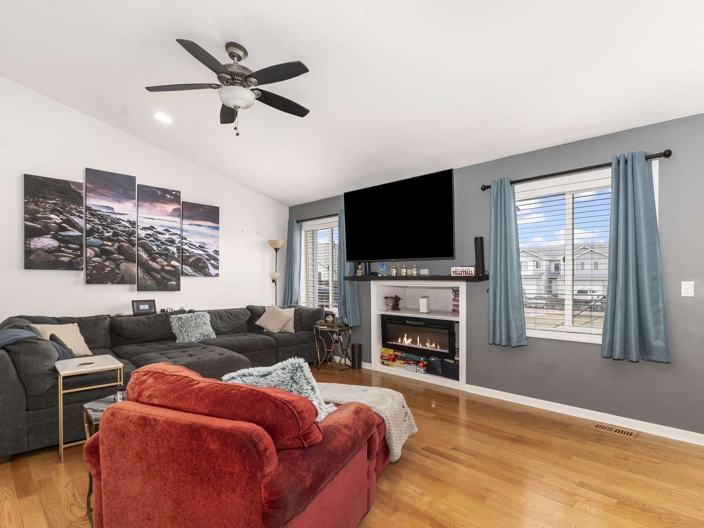 1923 Waters Edge Drive Minooka, IL 60447 - Photo 8 of 24 a living room with furniture a fireplace and a flat screen tv