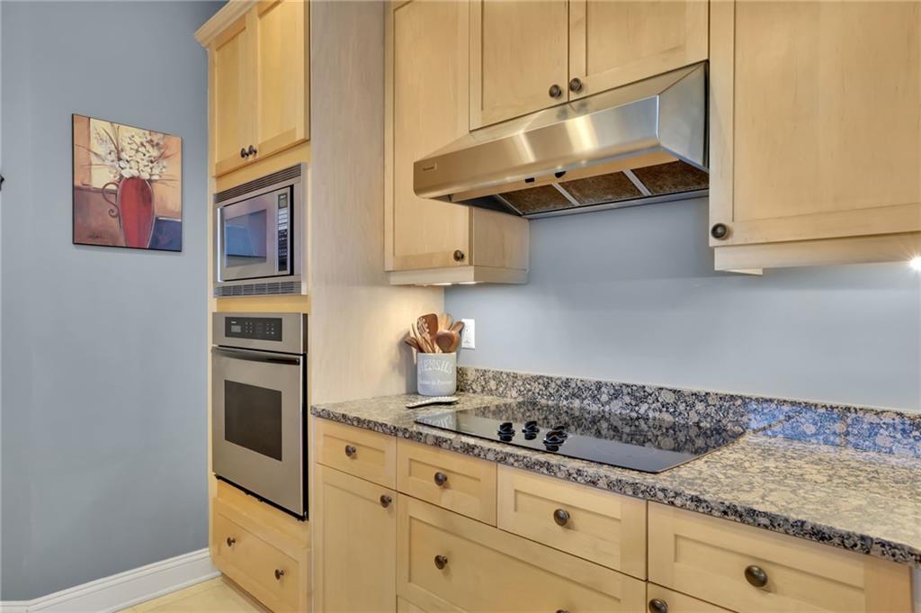 2828 Peachtree Road Northwest, Unit 1901 Atlanta, GA 30305 - Photo 11 of 35 a kitchen with stainless steel appliances granite countertop a sink and a stove