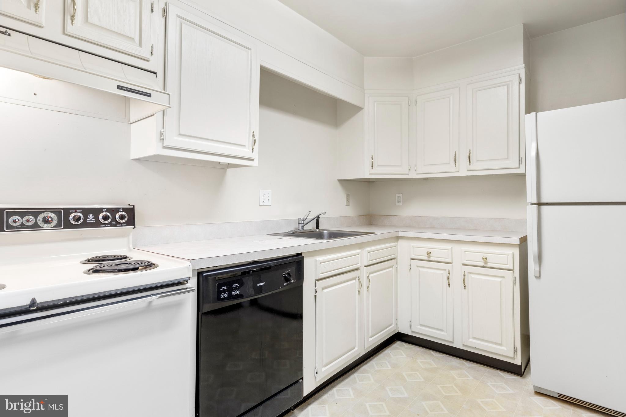 411 West Conestoga Road, Unit 18 Devon, PA 19333 - Photo 14 of 17 a kitchen with white cabinets and white appliances
