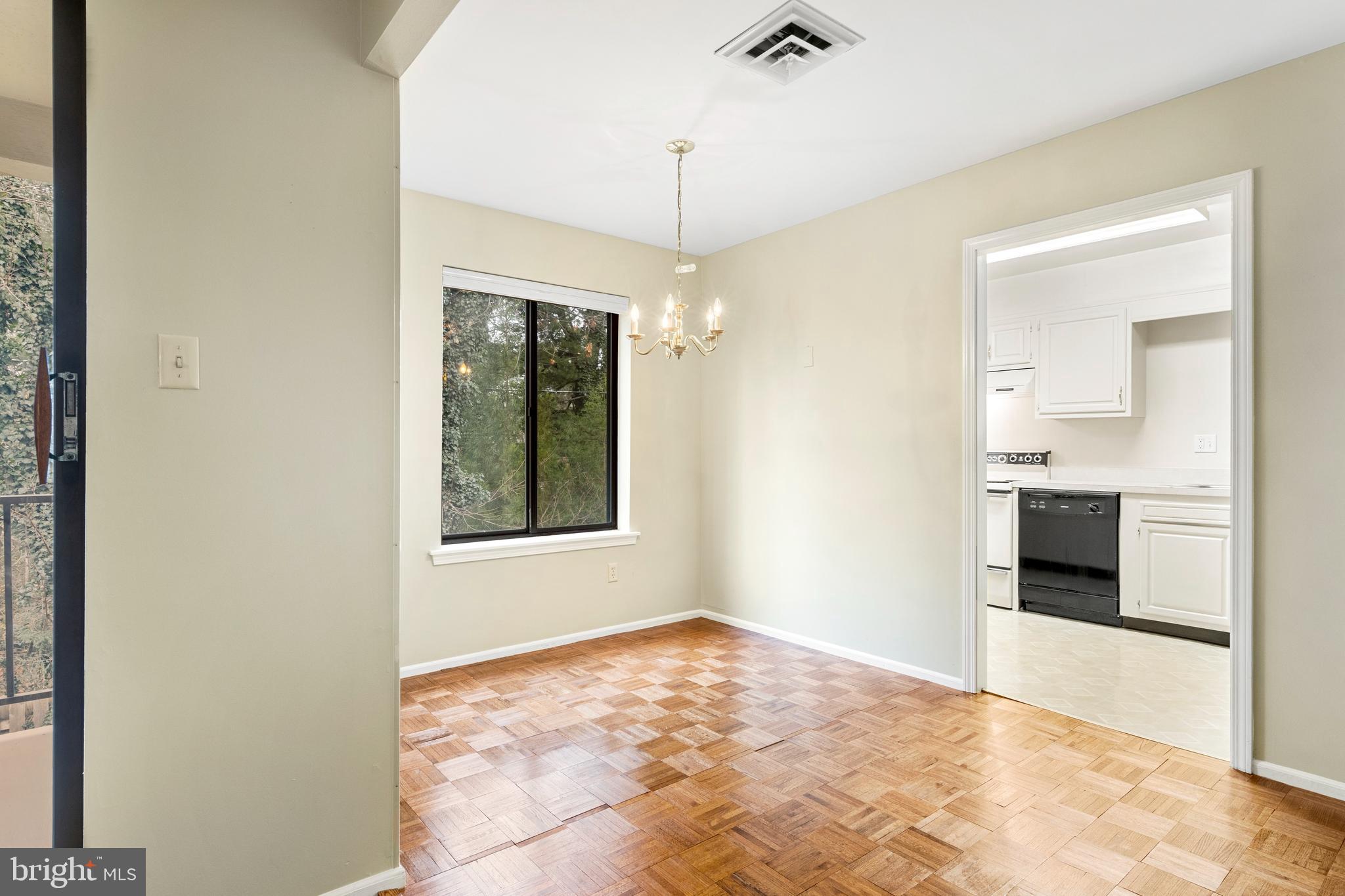411 West Conestoga Road, Unit 18 Devon, PA 19333 - Photo 5 of 17 a view of an empty room with kitchen and a window