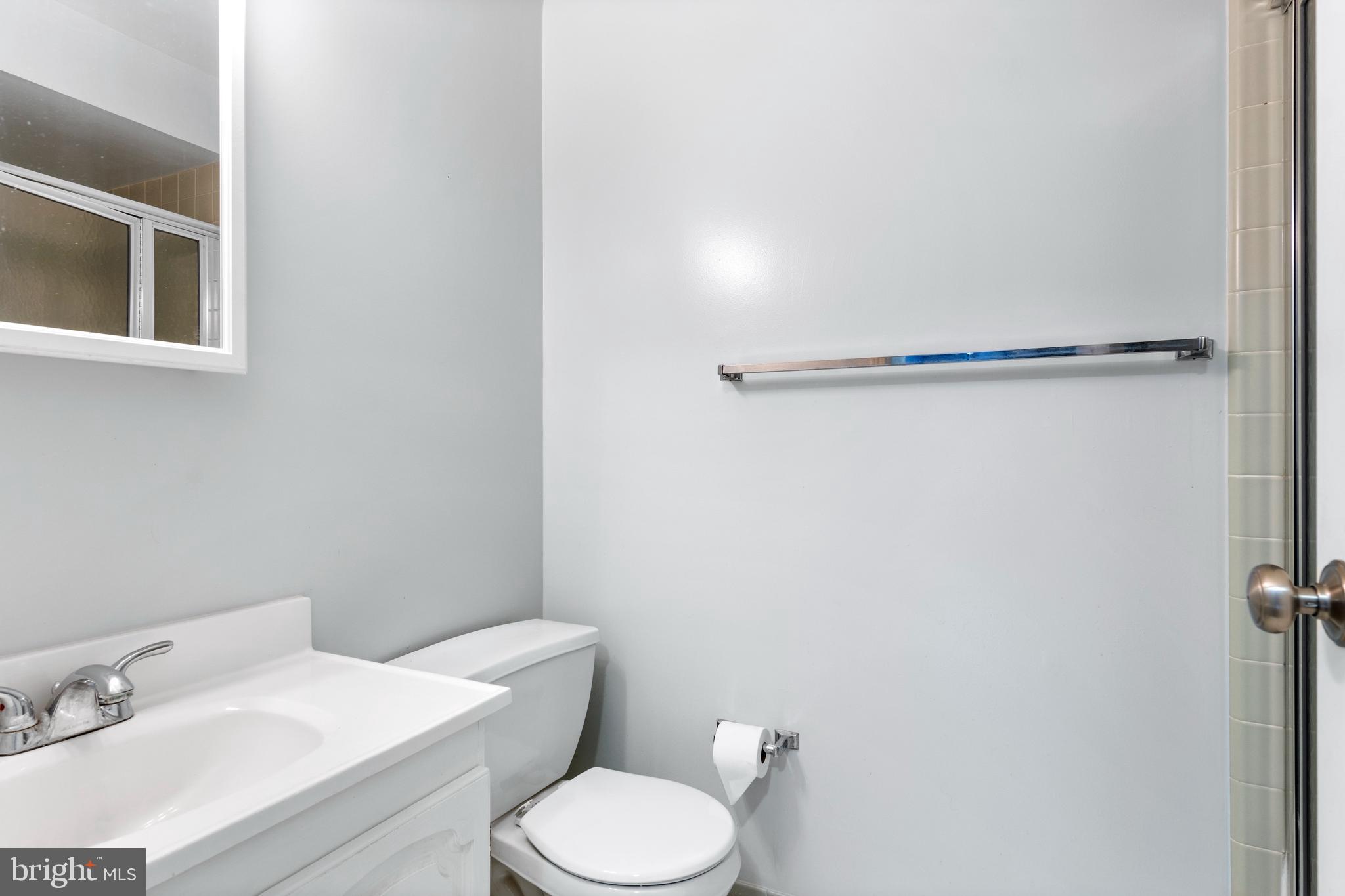 411 West Conestoga Road, Unit 18 Devon, PA 19333 - Photo 8 of 17 a white toilet sitting next to a bathroom sink