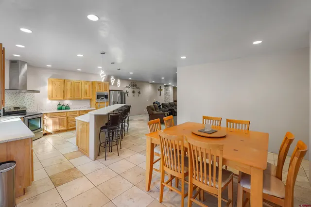 an open kitchen with kitchen island and stainless steel appliances