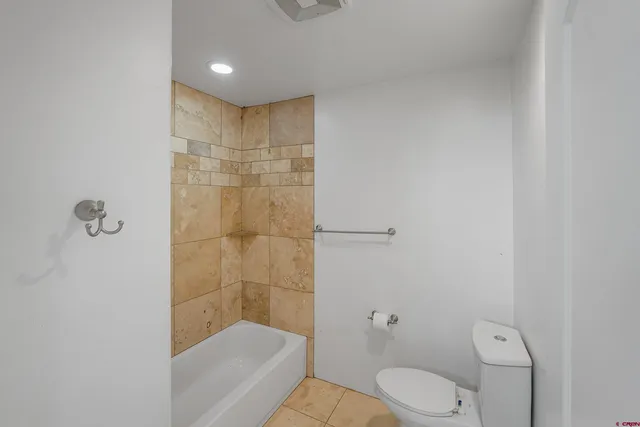 a bathroom with a toilet and shower