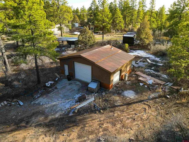 a view of a house with a yard and sitting area