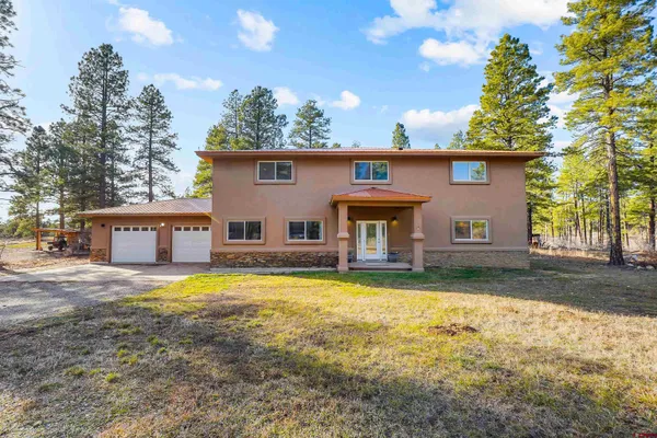 a view of a house with pool and a yard