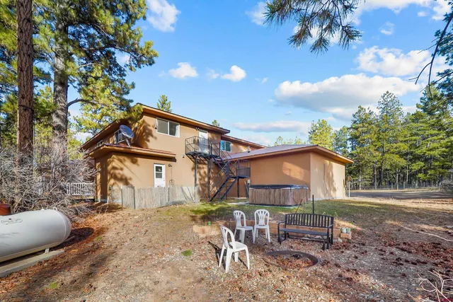 a backyard of a house with table and chairs