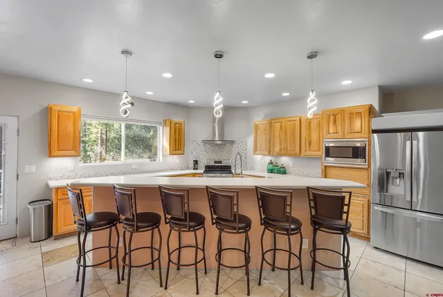 a kitchen with cabinets and chairs