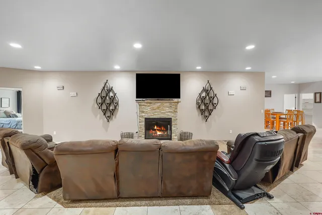 a living room with furniture a fireplace and a flat screen tv