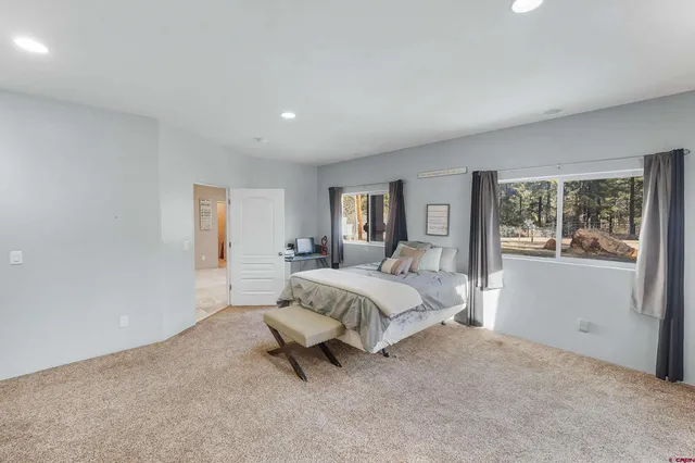 a spacious bedroom with a bed and a window