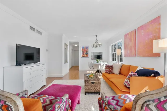 a bedroom with furniture and a flat screen tv