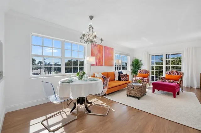 a living room with furniture windows and wooden floor