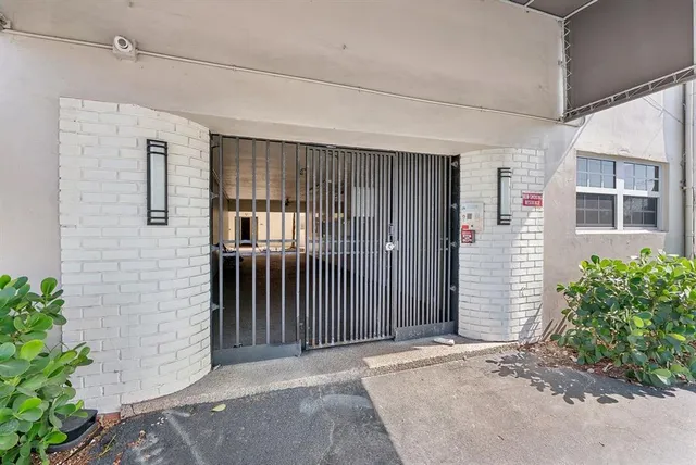 a view of a house with wooden fence