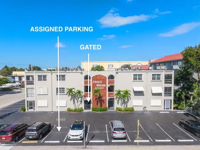 a view of a brick wall with building in the background