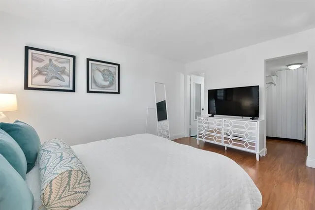 a bedroom with a bed and a flat screen tv