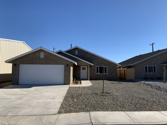 1536 Sims Street Ridgecrest, CA 93555 - Photo 1 of 19 a front view of a house with a yard and garage
