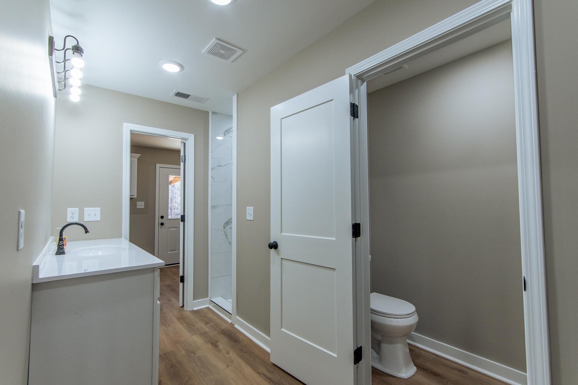 1471 Chambers Store Road Michie, TN 38357 - Photo 14 of 38 Bathroom featuring visible vents, wood finished floors, and toilet