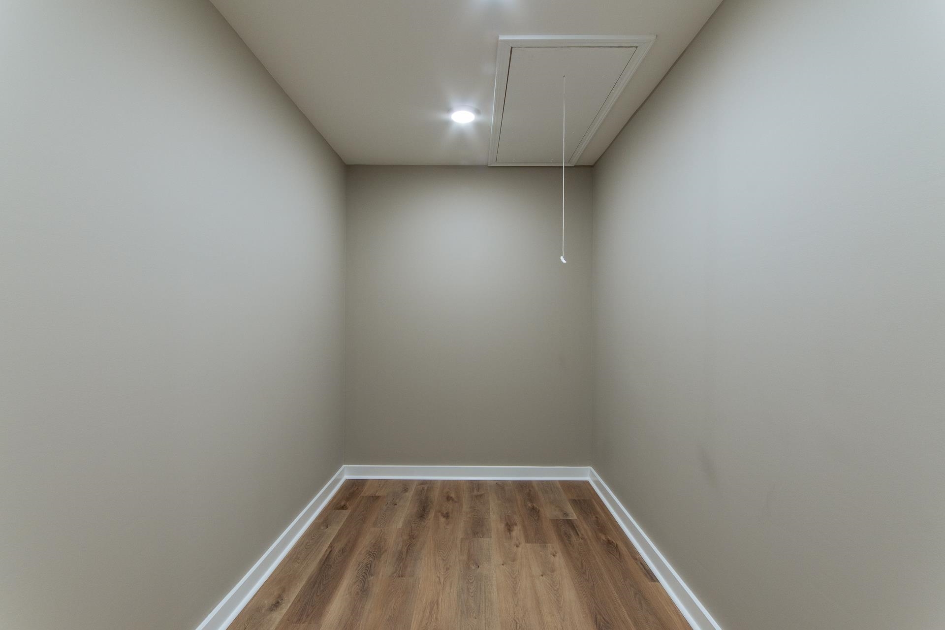 1471 Chambers Store Road Michie, TN 38357 - Photo 18 of 38 Spare room featuring baseboards, attic access, and wood finished floors