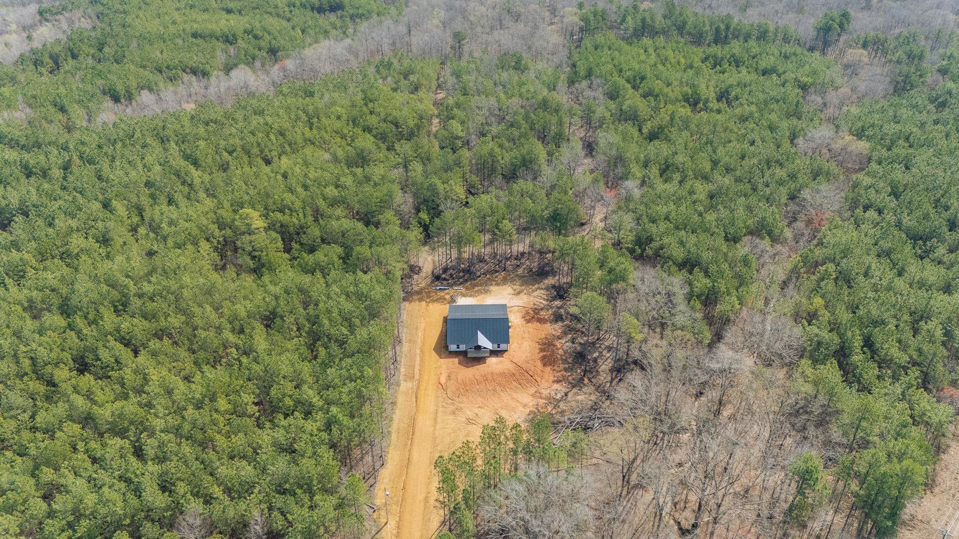 1471 Chambers Store Road Michie, TN 38357 - Photo 2 of 38 Bird's eye view featuring a wooded view