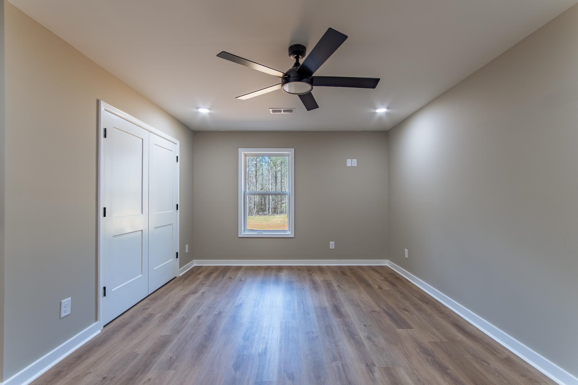 1471 Chambers Store Road Michie, TN 38357 - Photo 24 of 38 Unfurnished bedroom with a ceiling fan, wood finished floors, baseboards, and visible vents