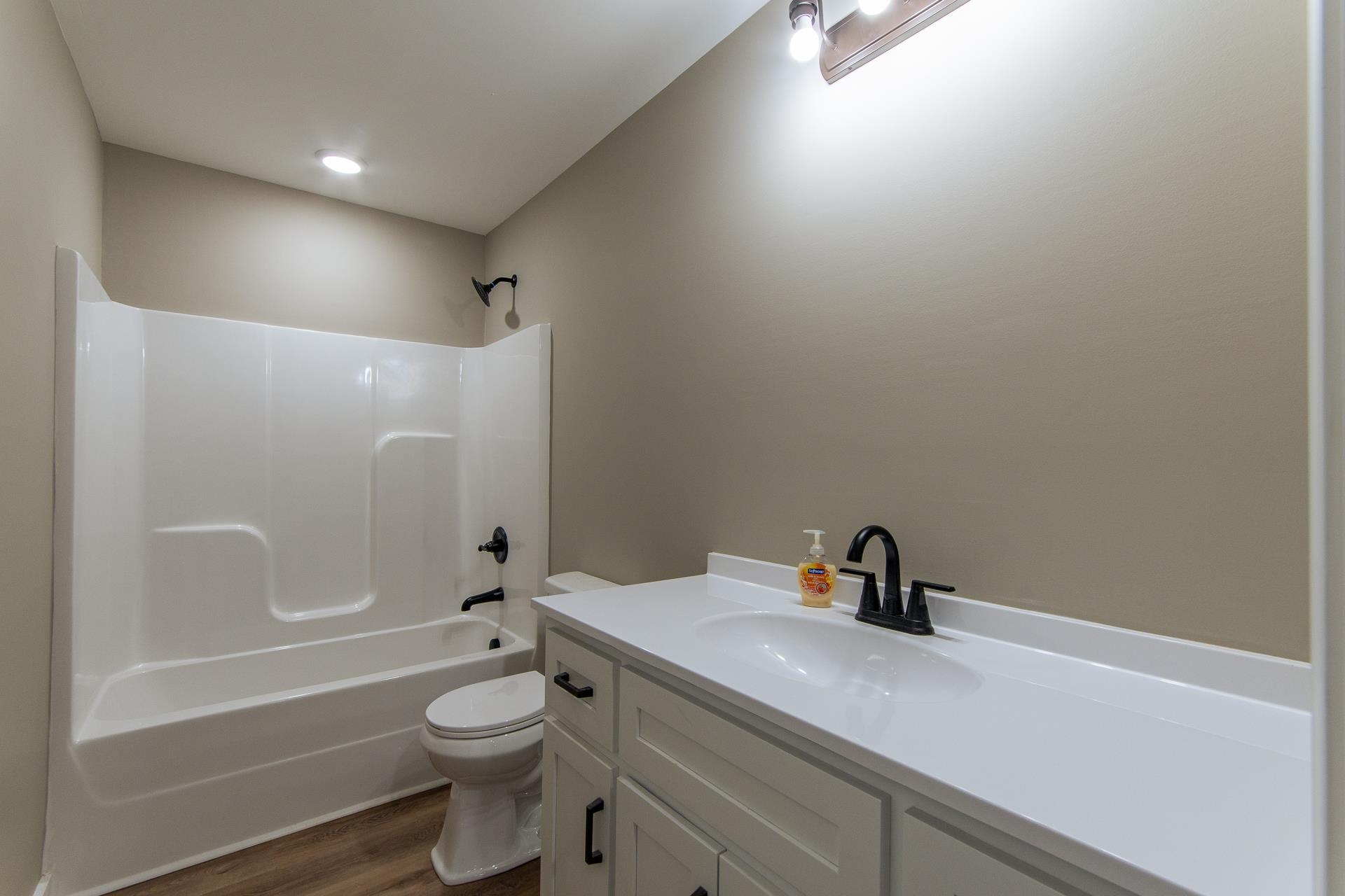 1471 Chambers Store Road Michie, TN 38357 - Photo 25 of 38 Bathroom with shower / washtub combination, toilet, vanity, and wood finished floors