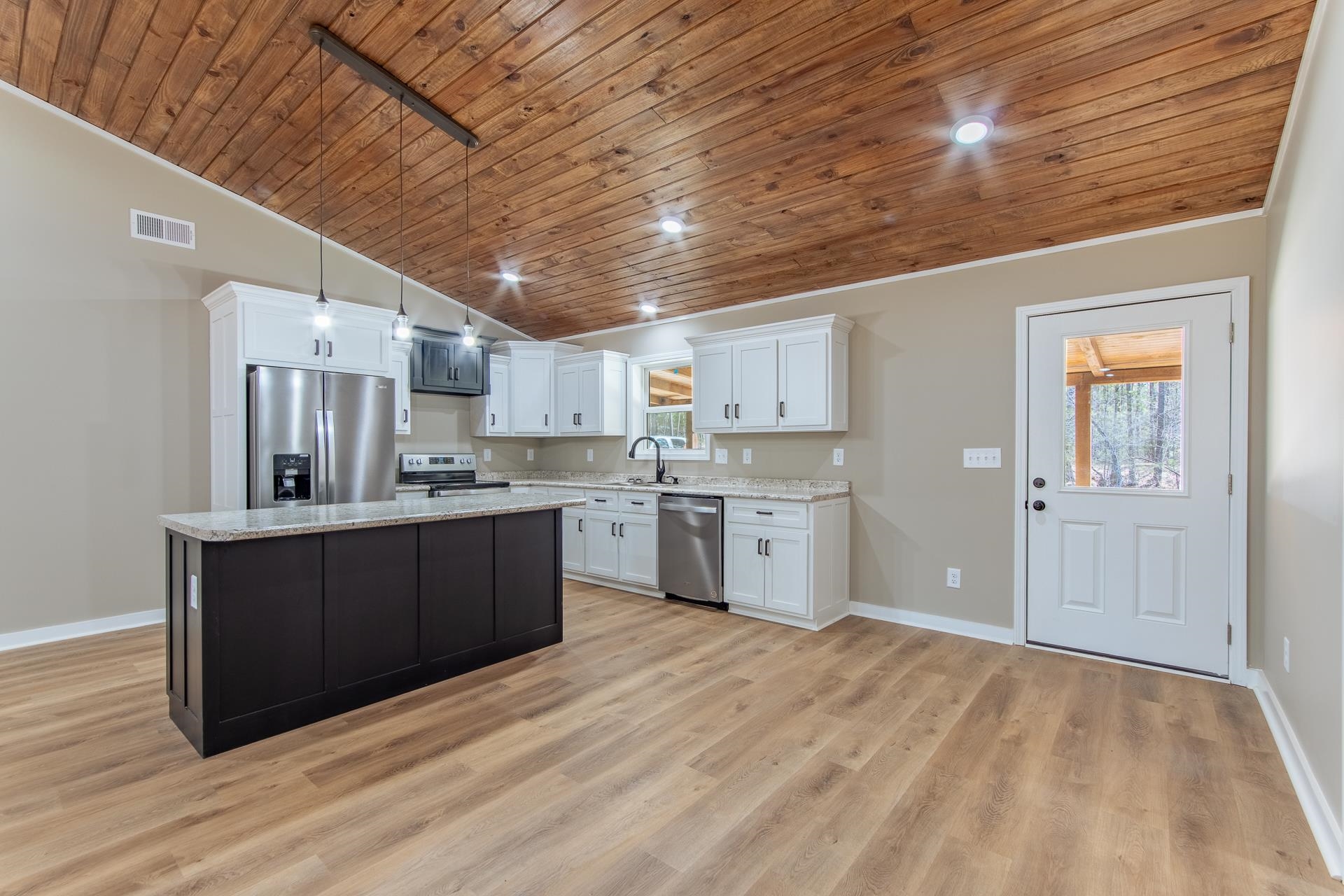 1471 Chambers Store Road Michie, TN 38357 - Photo 5 of 38 Kitchen with vaulted ceiling, a sink, appliances with stainless steel finishes, visible vents, and white cabinets