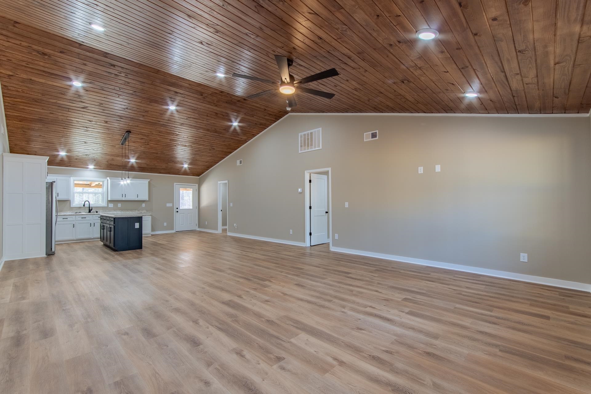 1471 Chambers Store Road Michie, TN 38357 - Photo 9 of 38 Unfurnished living room featuring light wood finished floors, baseboards, visible vents, and ceiling fan