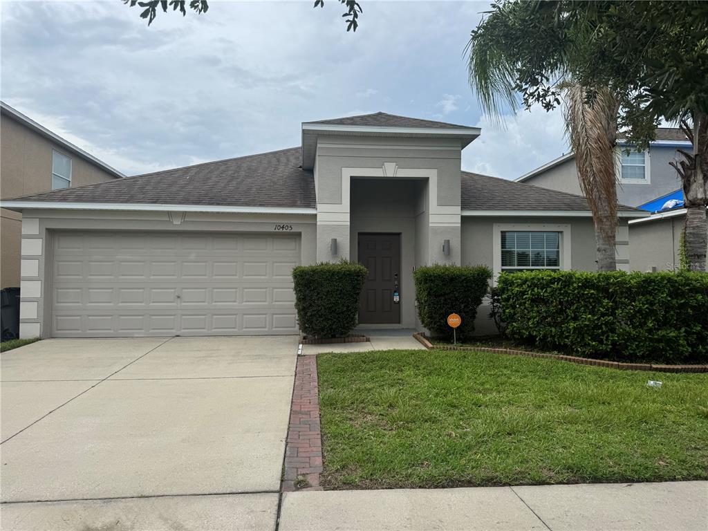 a view of house and yard with trees