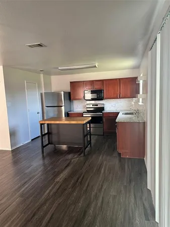 a kitchen with granite countertop stainless steel appliances and wooden cabinets