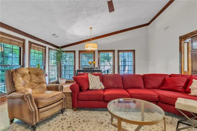 a dining room with furniture a rug and a chandelier