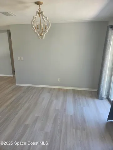 a view of a room with wooden floor and window