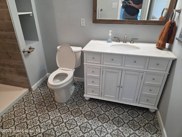 a bathroom with a sink toilet and mirror