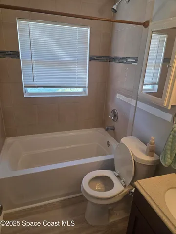 a bathroom with a toilet and a bathtub