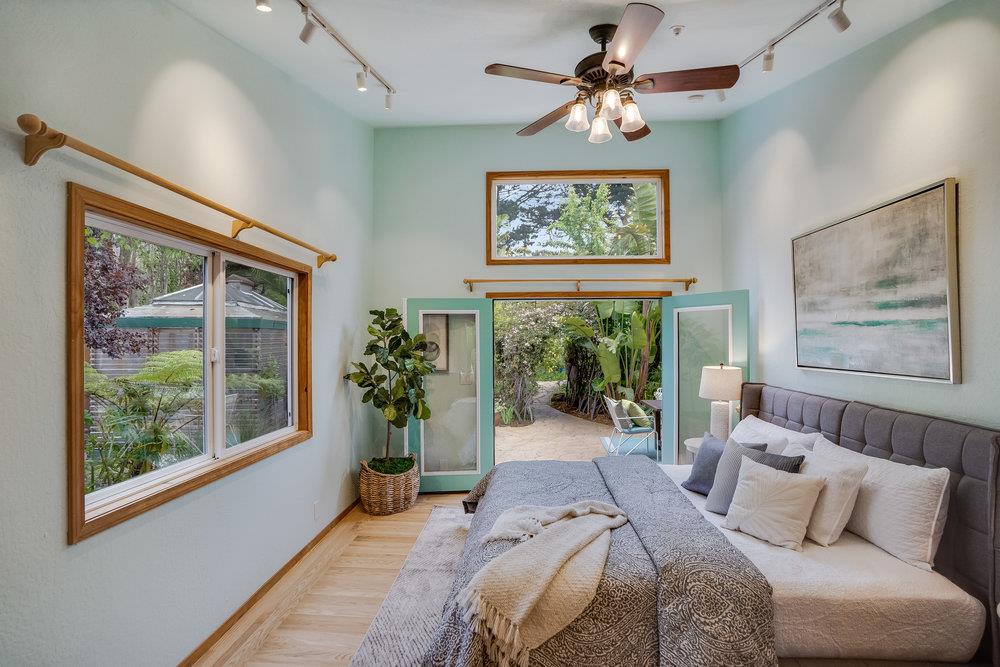 1067 Rio Vista Drive Pacifica, CA 94044 - Photo 13 of 43 a bed room with a bed and a painting on the wall