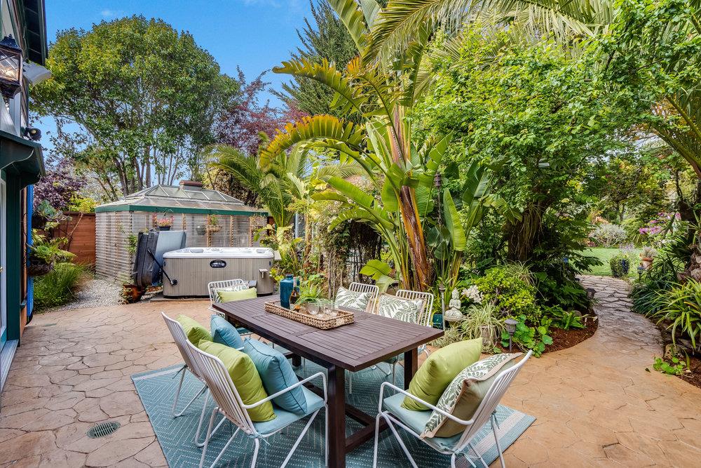 1067 Rio Vista Drive Pacifica, CA 94044 - Photo 20 of 43 a patio with table and chairs and potted plants