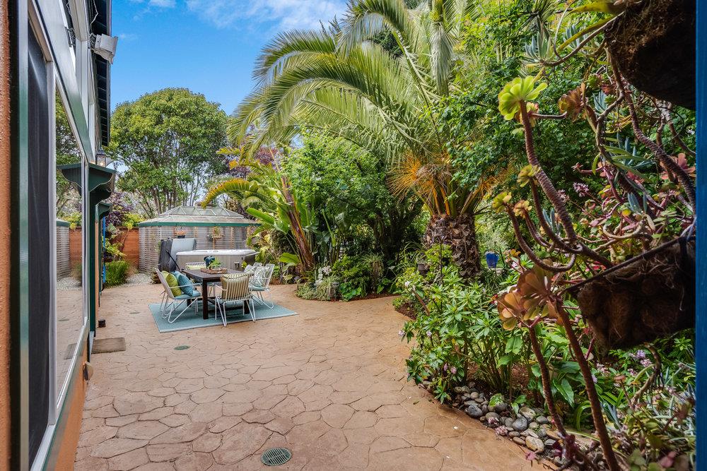 1067 Rio Vista Drive Pacifica, CA 94044 - Photo 21 of 43 a view of a patio with table and chairs and potted plants